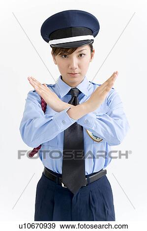 Stock Photo - A female security guard standing with her arms crossed. Fotosearch