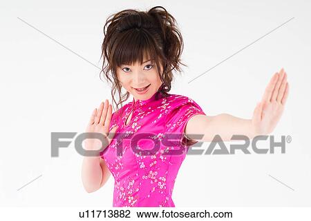 Stock Image - A young woman in Chinese dress posing. Fotosearch