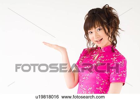 Stock Photograph - A young woman in Chinese dress smiling. Fotosearch