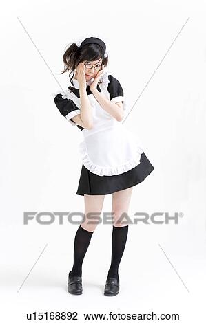 Stock Image - A young woman in French maid outfit smiling. Fotosearch