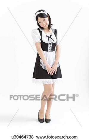 Stock Photo - A young woman in French maid outfit smiling. Fotosearch