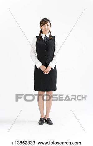 A young woman in uniform standing View Large Photo Image Stock Image - A young woman in uniform standing. Fotosearch