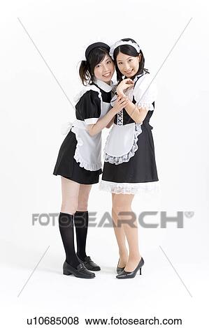 Stock Photo - Two young women in French maid outfit smiling. Fotosearch