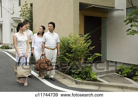 A family walking with luggage View Large Photo Image Stock Photo - A family walking with luggage. Fotosearch