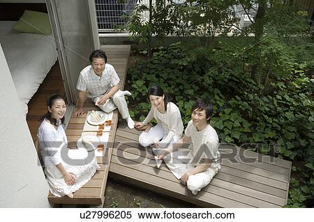 A family with adult children having lunch in porch View Large Photo Image Stock Photography - A family with adult children having lunch in porch. Fotosearch