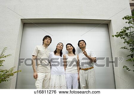A family with adult children standing in front of garage View Large Photo Image Stock Photograph - A family with adult children standing in front of garage. Fotosearch
