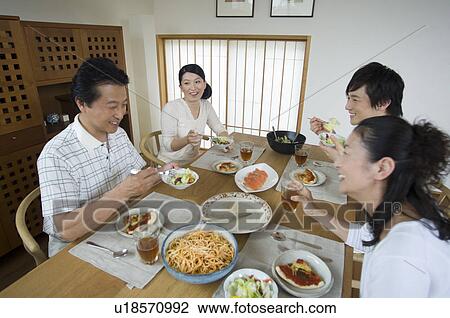 Stock Image - Family eating lunch at home. Fotosearch