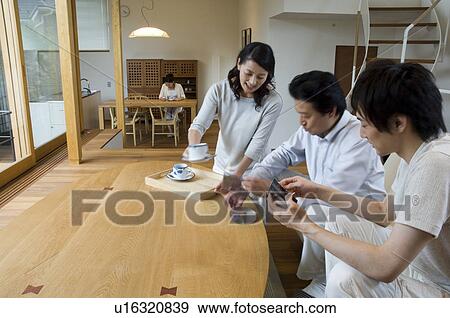 Stock Photo - Family relaxing at home. Fotosearch