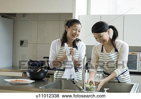Mother and daughter cooking in kitchen View Large Photo Image Stock Photo - Mother and daughter cooking in kitchen. Fotosearch