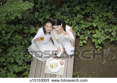 Mother and daughter eating lunch in porch View Large Photo Image Stock Image - Mother and daughter eating lunch in porch. Fotosearch