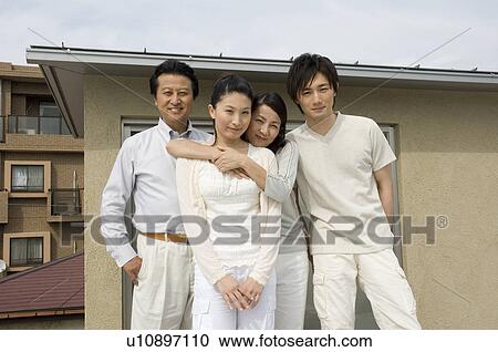 Stock Image - Portrait of a family with adult children. Fotosearch