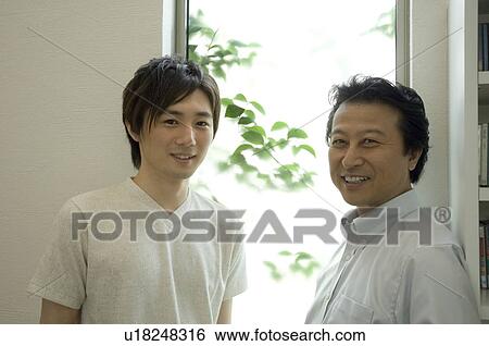 Stock Photograph - Portrait of father and adult son. Fotosearch