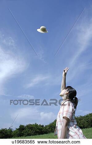 A young woman throwing a hat View Large Photo Image Stock Photography - A young woman throwing a hat. Fotosearch