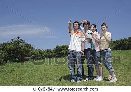 Stock Photo - Four young people looking ahead. Fotosearch