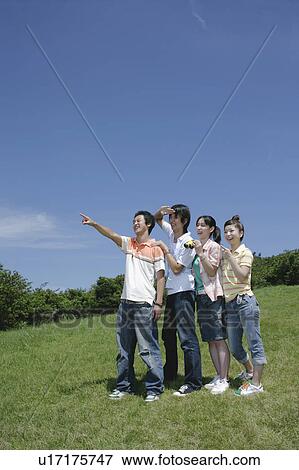 Stock Photo - Four young people looking ahead. Fotosearch
