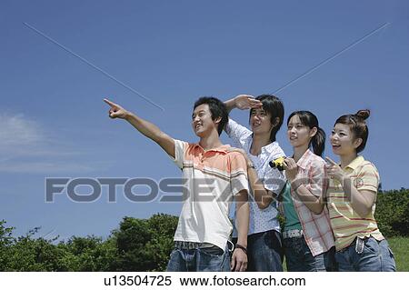 Stock Photography - Four young people looking ahead. Fotosearch