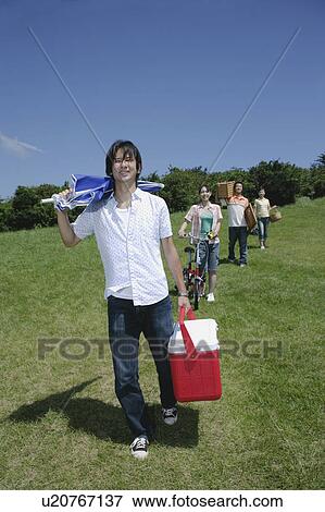 Four young people walking with picnic baskets View Large Photo Image Stock Photo - Four young people walking with picnic baskets. Fotosearch