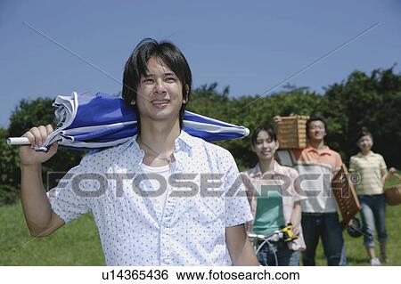 Four young people walking with picnic baskets View Large Photo Image Stock Photograph - Four young people walking with picnic baskets. Fotosearch