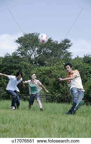 Three young people playing soccer View Large Photo Image Stock Image - Three young people playing soccer. Fotosearch