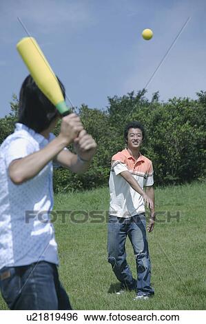 Two young men playing baseball View Large Photo Image Stock Photograph - Two young men playing baseball. Fotosearch