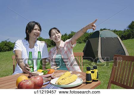 Stock Photo - Young couple enjoying picnic. Fotosearch