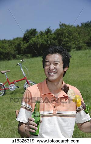 Young man eating kebab outside View Large Photo Image Stock Photo - Young man eating kebab outside. Fotosearch
