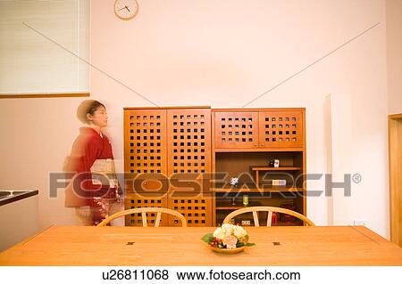 Stock Photo - A young woman wearing kimono walking, blurred motion. Fotosearch