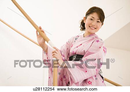 Picture - A young woman wearing yukata smiling. Fotosearch
