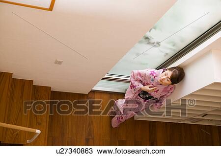 A young woman wearing yukata standing View Large Photo Image Stock Image - A young woman wearing yukata standing. Fotosearch