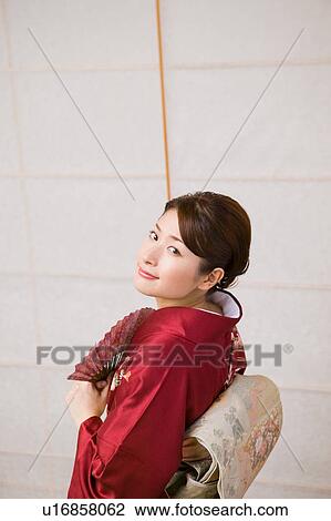 Portrait of a young woman wearing kimono View Large Photo Image Stock Image - Portrait of a young woman wearing kimono. Fotosearch