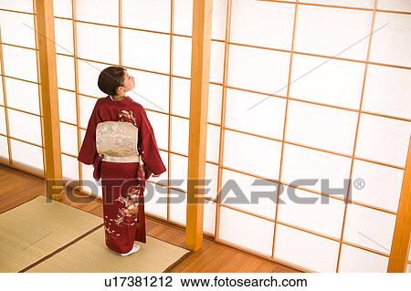 Stock Image - Portrait of a young woman wearing kimono. Fotosearch
