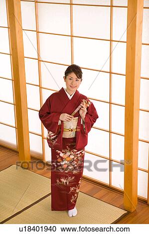 Stock Image - Portrait of a young woman wearing kimono. Fotosearch