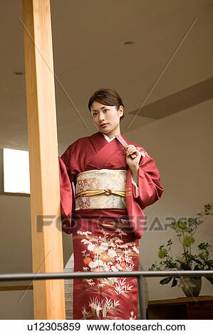 Portrait of a young woman wearing kimono View Large Photo Image Stock Photo - Portrait of a young woman wearing kimono. Fotosearch