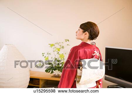 Stock Photo - Portrait of a young woman wearing kimono. Fotosearch