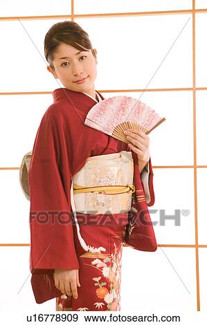 Portrait of a young woman wearing kimono View Large Photo Image Stock Photo - Portrait of a young woman wearing kimono. Fotosearch