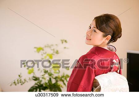 Stock Photo - Portrait of a young woman wearing kimono. Fotosearch