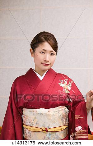Portrait of a young woman wearing kimono View Large Photo Image Stock Photograph - Portrait of a young woman wearing kimono. Fotosearch