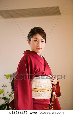 Portrait of a young woman wearing kimono View Large Photo Image Stock Photography - Portrait of a young woman wearing kimono. Fotosearch