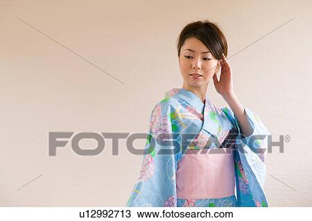 Portrait of a young woman wearing yukata View Large Photo Image Stock Image - Portrait of a young woman wearing yukata. Fotosearch