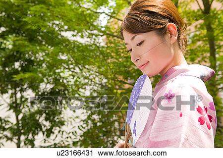 Portrait of a young woman wearing yukata View Large Photo Image Stock Image - Portrait of a young woman wearing yukata. Fotosearch