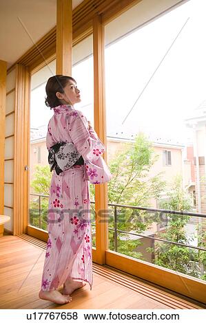 Stock Photo - Portrait of a young woman wearing yukata. Fotosearch