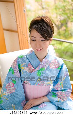 Stock Image - Portrait of young woman wearing yukata. Fotosearch