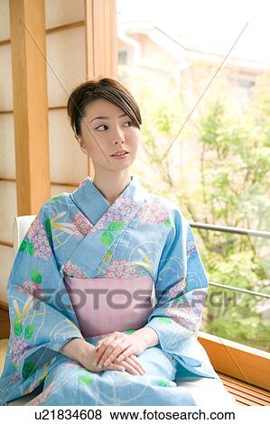 Stock Photo - Portrait of young woman wearing yukata. Fotosearch