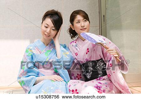 Two young women wearing yukata sitting on porch View Large Photo Image Stock Photograph - Two young women wearing yukata sitting on porch. Fotosearch