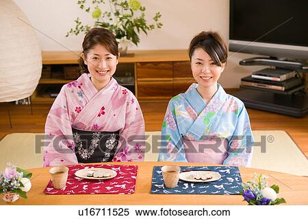 Two young women wearing yukata sitting View Large Photo Image Stock Photography - Two young women wearing yukata sitting. Fotosearch