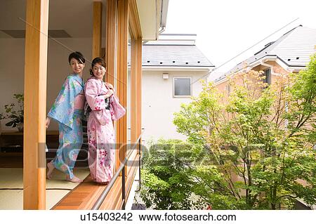Two young women wearing yukata standing View Large Photo Image Stock Image - Two young women wearing yukata standing. Fotosearch