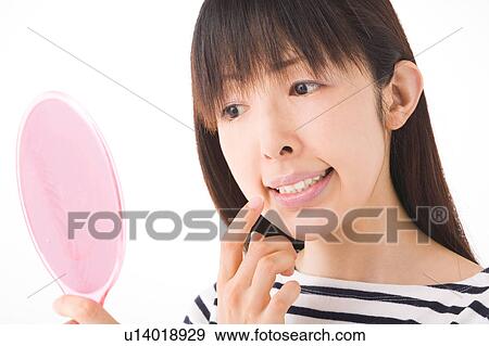 A woman looking at teeth with mirror View Large Photo Image Stock Photo - A woman looking at teeth with mirror. Fotosearch