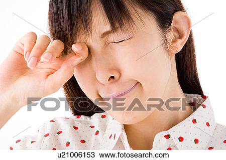 A woman rubbing her eyes View Large Photo Image Stock Image - A woman rubbing her eyes. Fotosearch