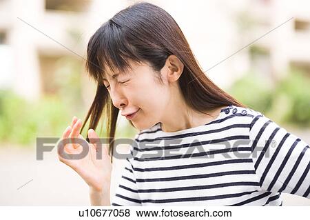 A woman sneezing View Large Photo Image Stock Photo - A woman sneezing. Fotosearch