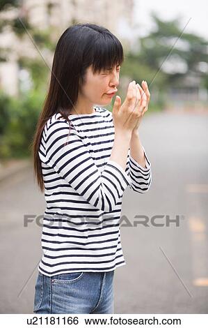 A woman sneezing View Large Photo Image Stock Photograph - A woman sneezing. Fotosearch